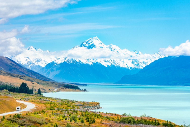 A motorhome below Aoraki / Mount Cook and Lake Pukaki