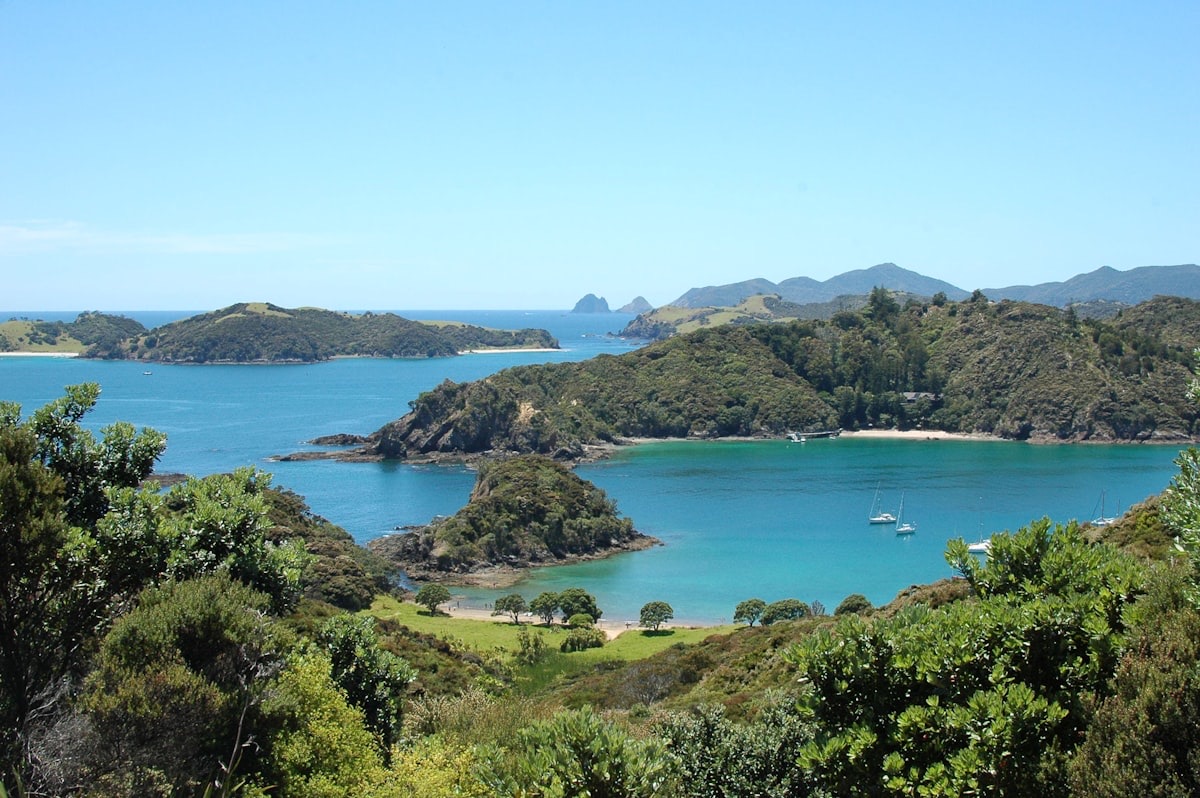 The turquoise bays and green islands of the Bay of Islands in Northland, with yachts at anchor