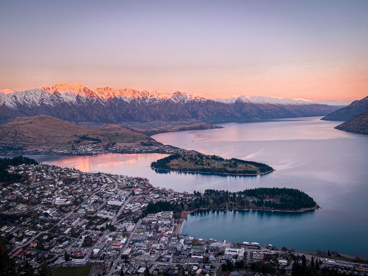 Queenstown on the shore of Lake Wakatipu with The Remarkables mountain range behind at sunset