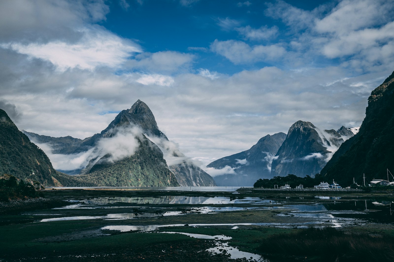 Mitre Peak rising under heavy cloud at Milford Sound, showing the fast-changing Fiordland weather